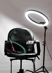 black armchair beside rim light with stand thumbnail