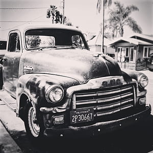 grayscale photography of GMC single cab pickup truck outdoors thumbnail