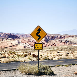 curvy road sign on next 4 miles on side of road thumbnail
