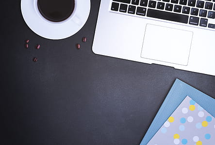 Black work desk with a laptop, coffee and block thumbnail