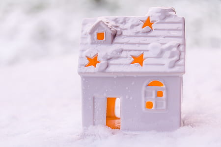 white house miniature on top of snow field thumbnail