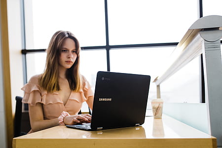 woman sitting while typing on laptop thumbnail