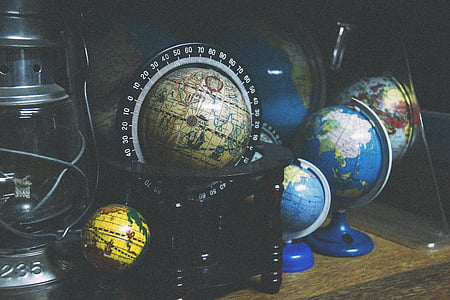 black terrestrial globe and three desk globes thumbnail