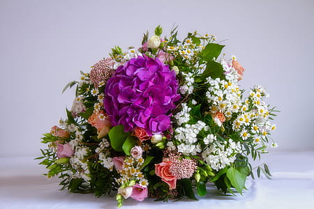 assorted-color petaled flower centerpiece on white surface thumbnail