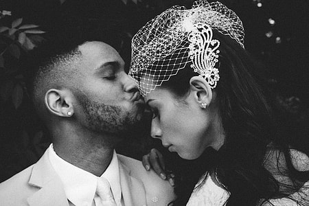 gray scale photo of man kissing a girl on forehead thumbnail