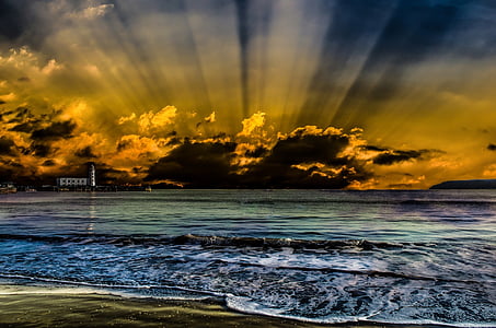 seashore and sea water across white lighthouse and sunset painting thumbnail