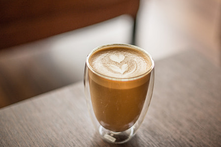 clear glass cup with espresso on top of a wooden table thumbnail