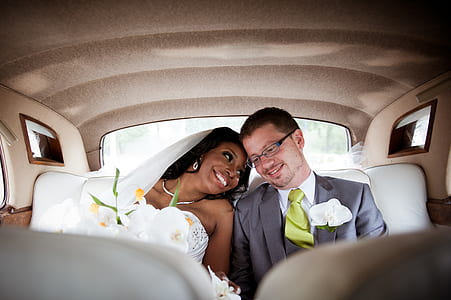 bride and groom inside vehicle during day time thumbnail