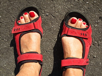 woman wearing pair of red-and-black sandals thumbnail
