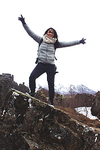 Woman Standing on a Rock Wearing Bubble Jacket thumbnail