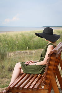 woman sitting on brown wooden bench thumbnail