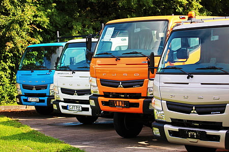 four assorted-color Fuso trucks thumbnail
