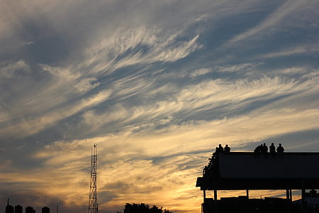 Silhouette of Building With People Standing during Golden Hour thumbnail