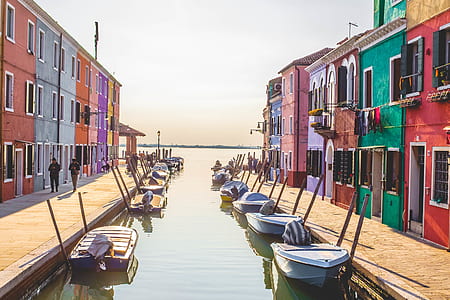 sailboats and multicolored building during daytime thumbnail