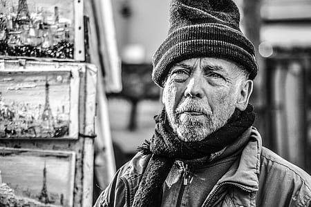 grayscale photography of man in knit cap and jacket thumbnail