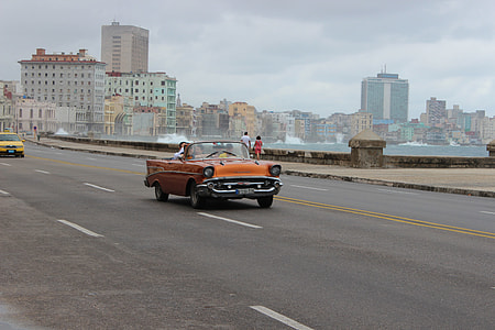classic orange convertible coupe on asphalt road during daytime thumbnail