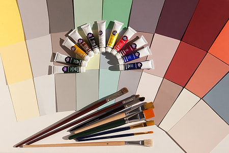 photo of assorted-color paint brushes and paint color soft tubes thumbnail