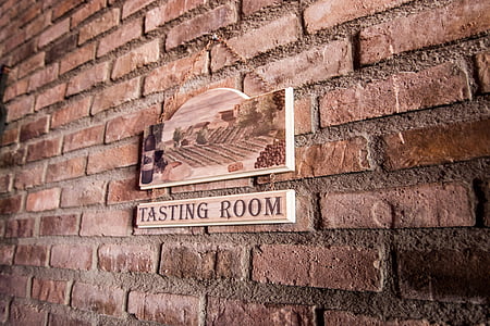 tasting room wooden sign on brick wall thumbnail