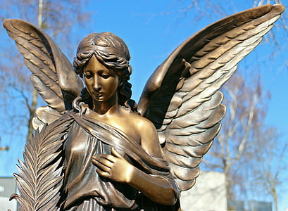 brown steel angel figurine during daytime thumbnail