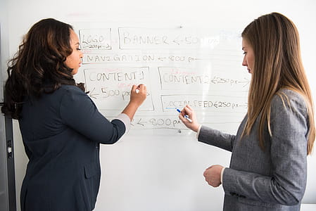 Two Women Writing on Dry Erase Board thumbnail