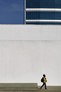 man standing near on white wall paint thumbnail