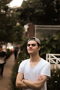 shallow focus photography of man standing with crossed arms thumbnail