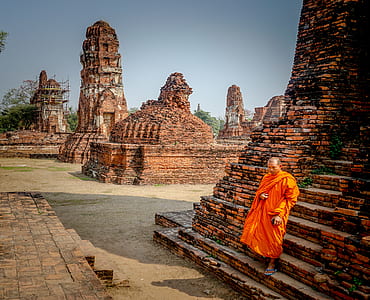 man standing near temple during daytime thumbnail
