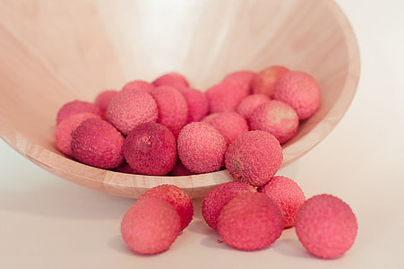 pink fruits on round brown bowl thumbnail
