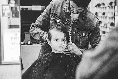 grayscale photo of boy having haircut thumbnail