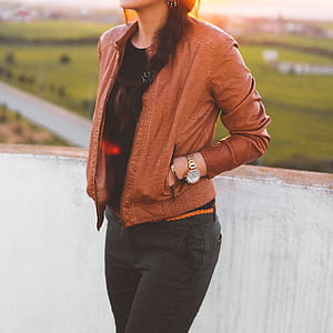 woman wearing brown jacket while hand on her pocket thumbnail