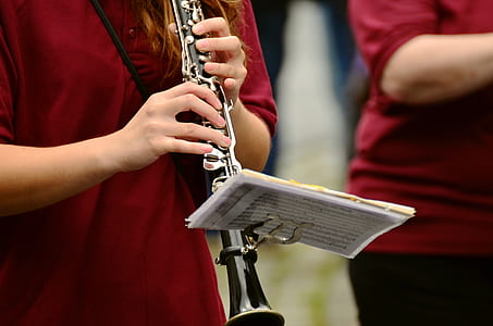 black and silver clarinet with musical note holder during daytime thumbnail