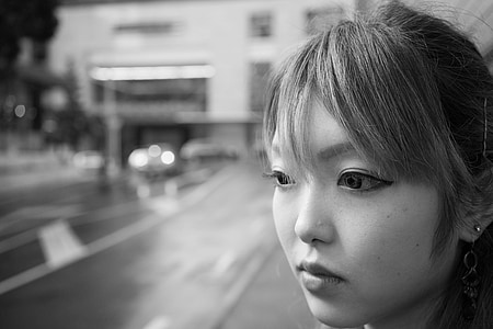 greyscale photography of woman standing near road thumbnail