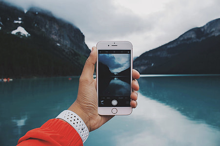 silver iphone 6 taking picture of lake during cloudy day thumbnail