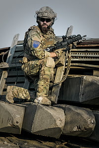soldier kneeling while holding black rifle thumbnail