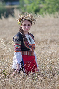 selective focus photo of woman standing on wheat field during daytime thumbnail