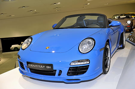 blue Porsche convertible coupe on display thumbnail