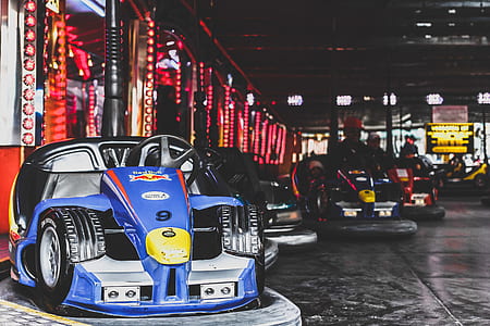 person rides black go kart inside building thumbnail