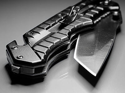 photography of black handled pocketknife on gray surface thumbnail