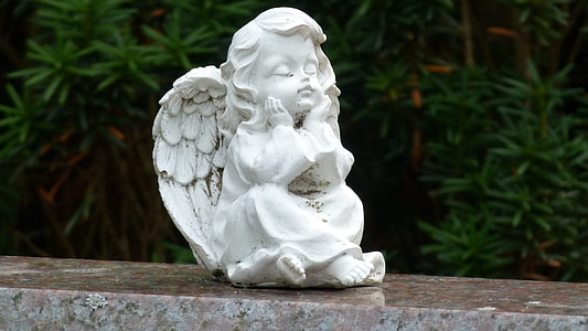 white ceramic cherub during daytime thumbnail