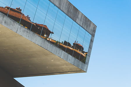reflection of houses on building windows during daytime thumbnail