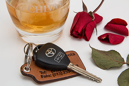 black and silver Toyota key beside red rose thumbnail