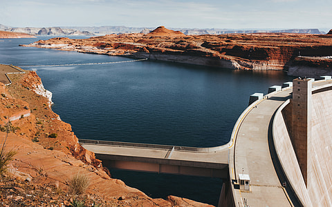 aerial photography of concrete dam under clear blue sky thumbnail