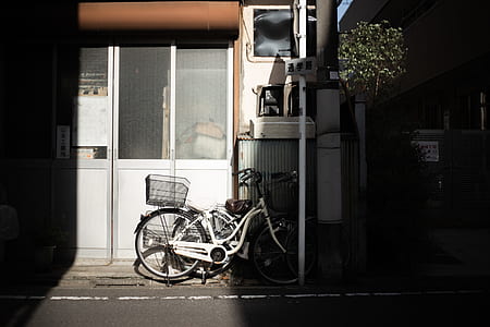 white bike parked in front of white door thumbnail