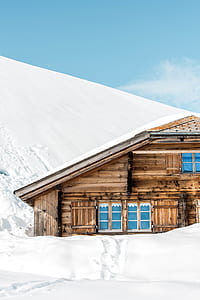 brown chalet house covered with snow thumbnail