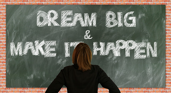 person in black long-sleeved shirt standing front of Dream Big & Make It Happen text thumbnail