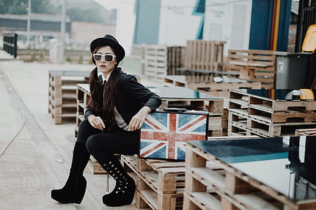 woman sitting on brown wooden pallet thumbnail