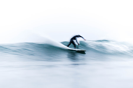 person surfing on sea wave during daytime thumbnail