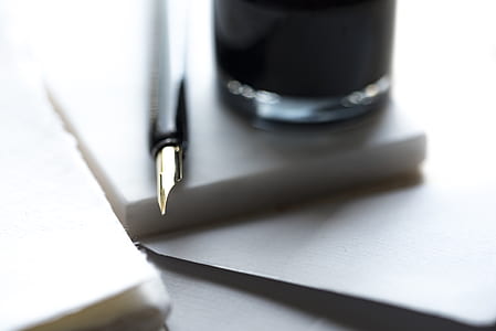 black fountain pen beside clear glass thumbnail