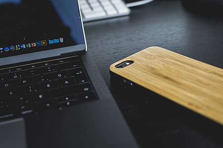 laptop computer beside smartphone on table thumbnail