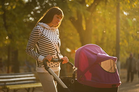 Woman Holding Pink And Black Stroller thumbnail